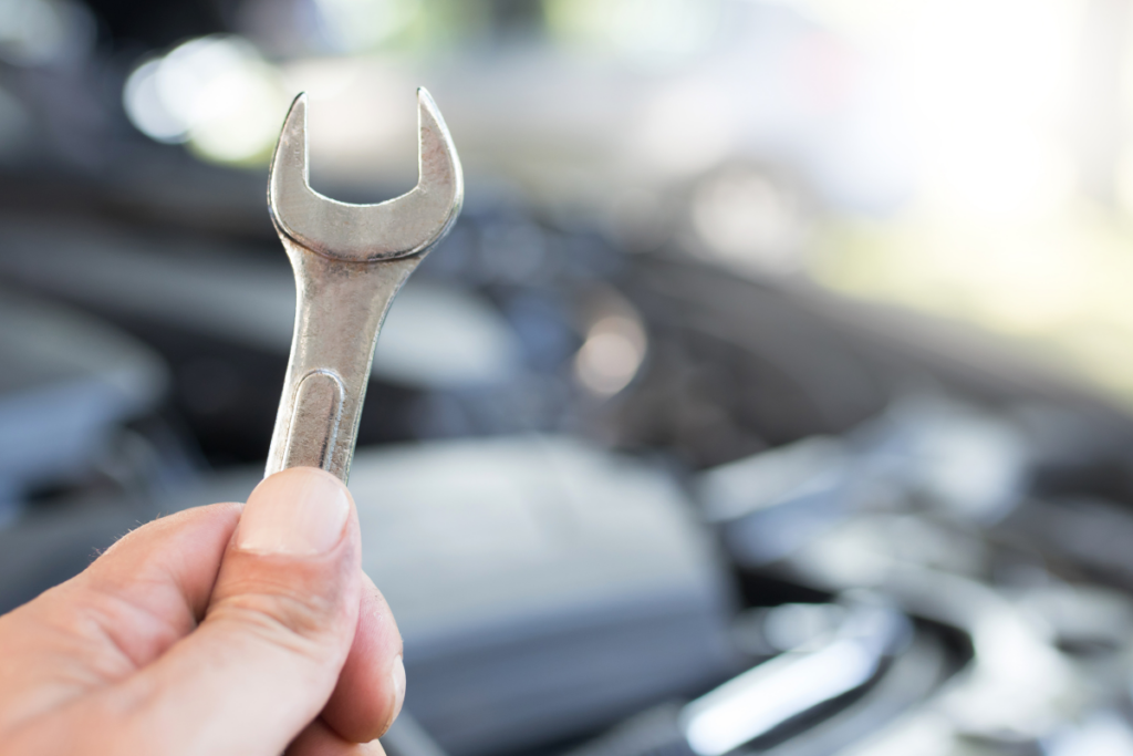 A Person Holding A Wrench - Arrow Automotive - Automotive Metal Fabrication Suppliers